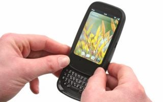Hands holding a Palm Pre 2 smartphone with keyboard extended.