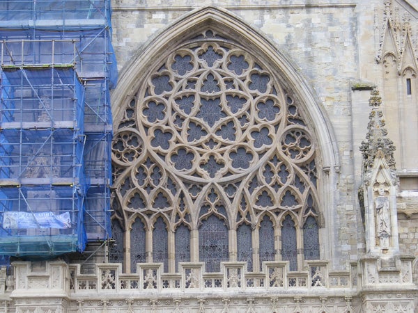 Gothic cathedral window with scaffolding on the left side.