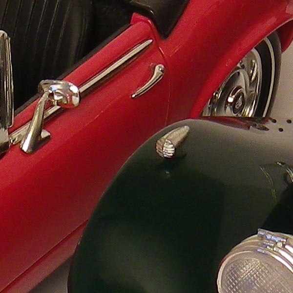 Close-up of a red and green vintage car model