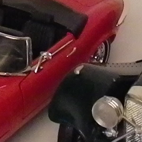 Close-up of a red toy car's side profile