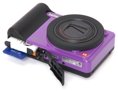 Pentax Optio RZ10 camera in purple with batteries.