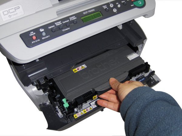 Person changing toner in Brother DCP-7045N printer