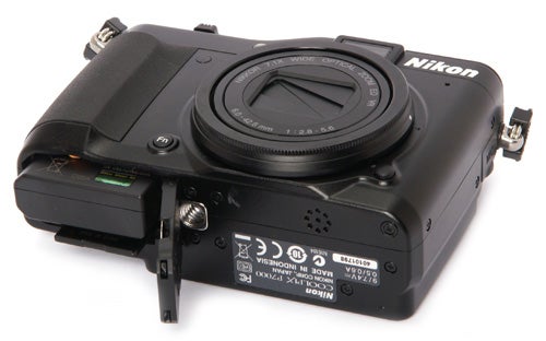Nikon CoolPix P7000 camera with open memory card slot.