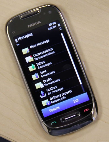 Nokia C7 smartphone displaying messaging menu on screen.
