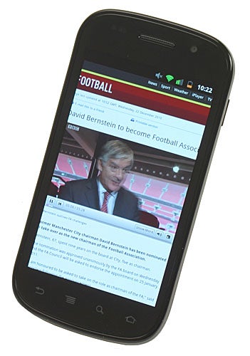 Google Nexus S smartphone displaying a football news website.