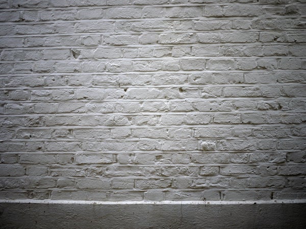 White brick wall with shadow detail captured by camera.
