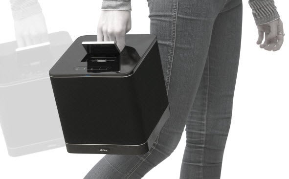 Person carrying an Arcam rCube portable speaker.