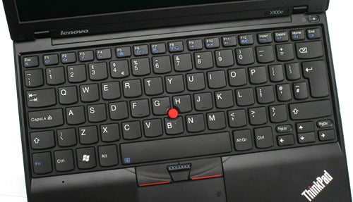 Lenovo ThinkPad X100e laptop keyboard and trackpoint detail.