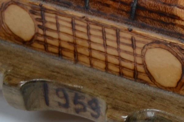 Close-up of a guitar neck with the year 1953 visible.