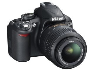 Nikon D3100 DSLR camera with lens attached.