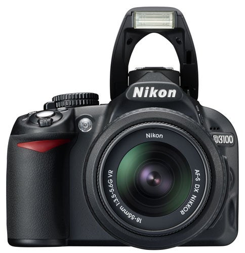 Nikon D3100 DSLR camera with lens and flash raised.