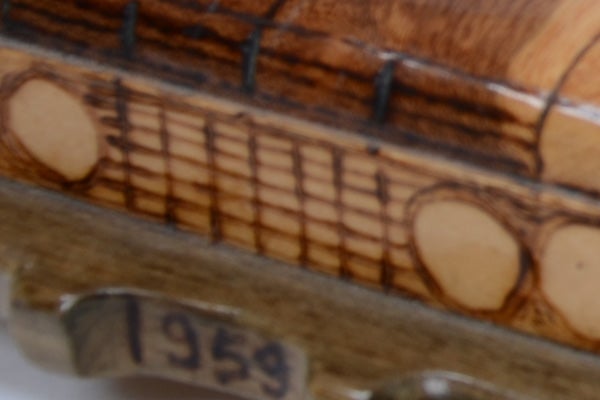 Close-up of a blurred wooden object with unclear engravings.