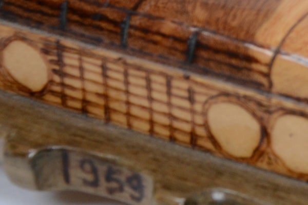 Close-up photo of a wooden surface with blurred digits '1959'.