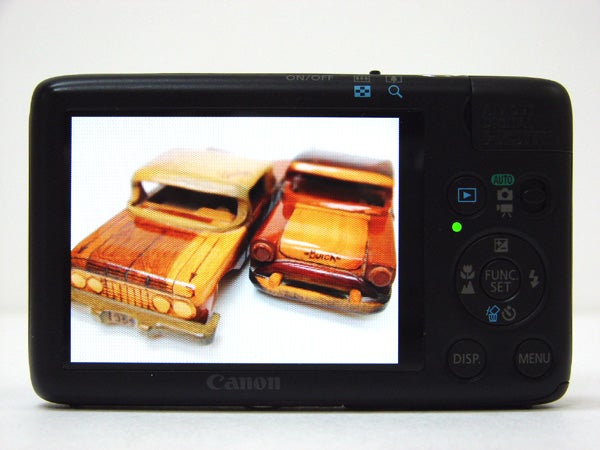 Canon IXUS 130 camera displaying photo of toy cars.
