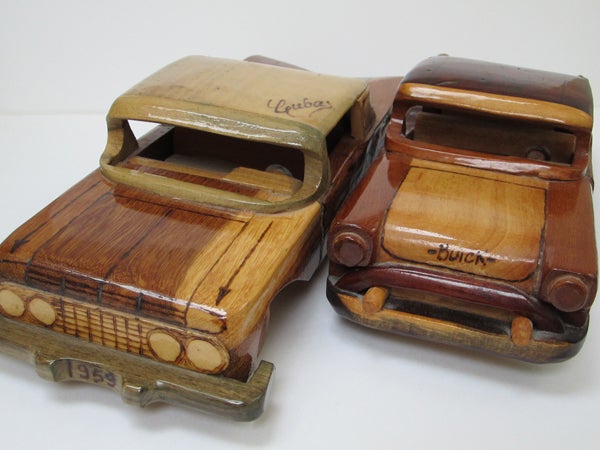 Handcrafted wooden models of a 1959 Chevrolet and Buick cars.