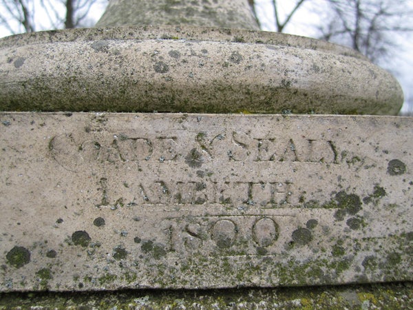 Close-up of weathered inscription on stone dating to 1800.