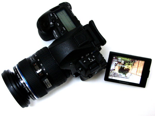 Olympus E-5 DSLR camera with articulated LCD screen displayed.