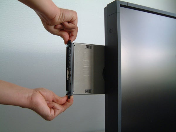 Person inserting card into NEC MultiSync P461 monitor.