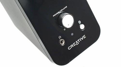 Close-up of Creative T12 Wireless speaker controls and logo