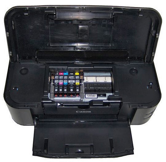 Canon PIXMA iP4850 inkjet printer with open cover showing ink cartridges.