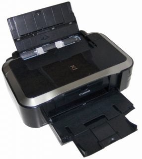 Canon PIXMA iP4850 inkjet printer with open trays.