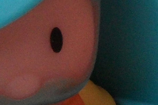 Close-up of a colorful stuffed toy's face