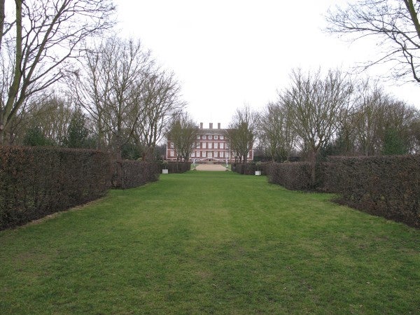 Photo of a manor seen through hedged pathway captured with Canon G12.