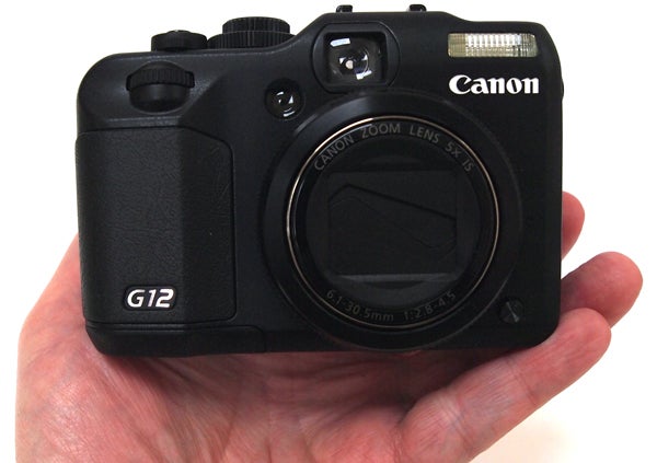 Canon PowerShot G12 camera held in a hand.