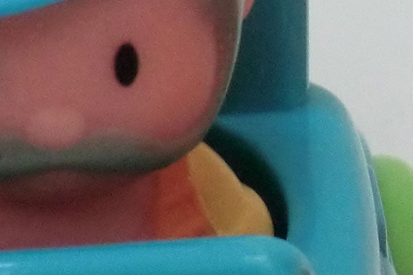 Close-up of a toy's face and seat.