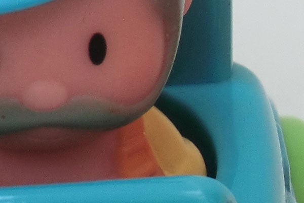 Close-up of a toy figure's face in soft focus.