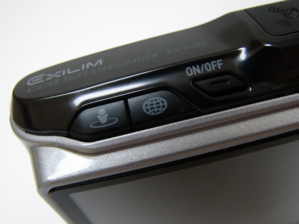 Casio Exilim EX-H20G camera's on/off button and logo detail.