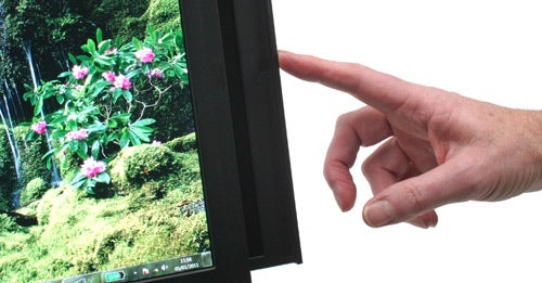 Hand pointing to Lenovo ThinkPad W701ds laptop screen.