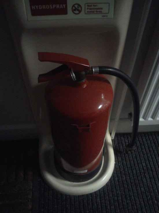 Red fire extinguisher mounted on wall