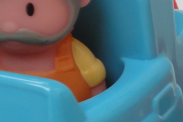 Close-up of a plastic toy character in a car.