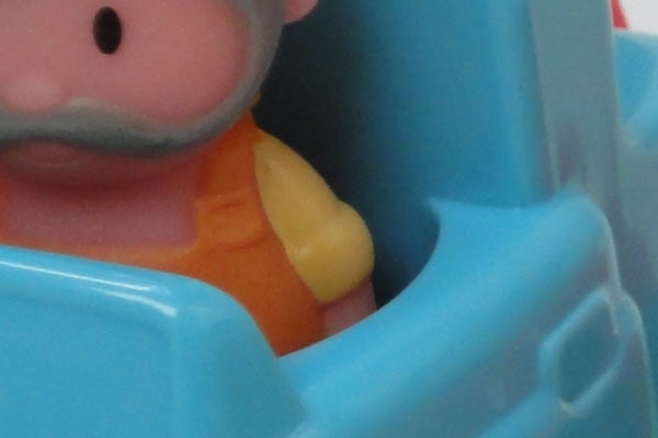 Close-up of a toy figure in a blue car