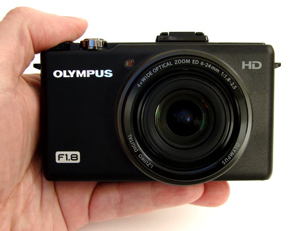 Hand holding the Olympus XZ-1 digital camera.