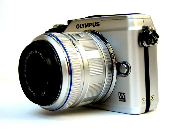 Olympus E-PL2 camera with silver body and black lens.