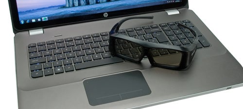 HP Envy 17 3D laptop with 3D glasses on keyboard.