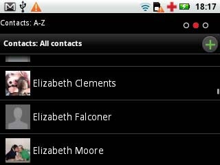 Motorola Flipout phone displaying contact list screen.