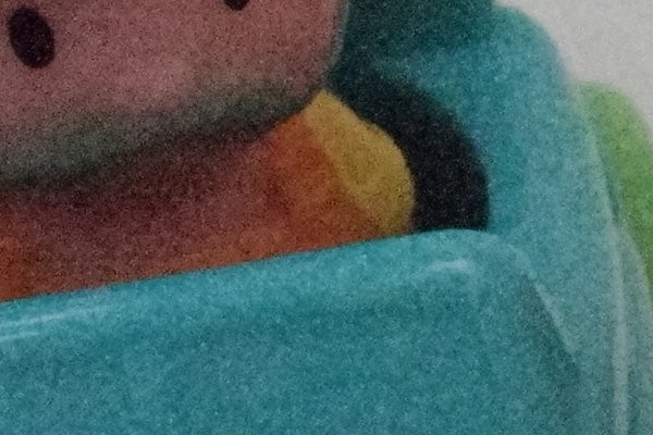 Close-up of a colorful plush toy's face