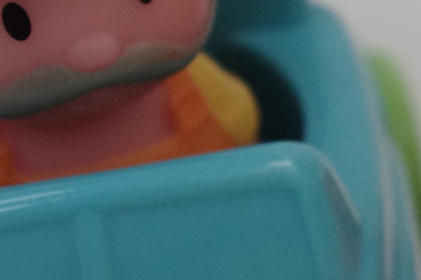 Close-up of a colorful plastic toy's face.
