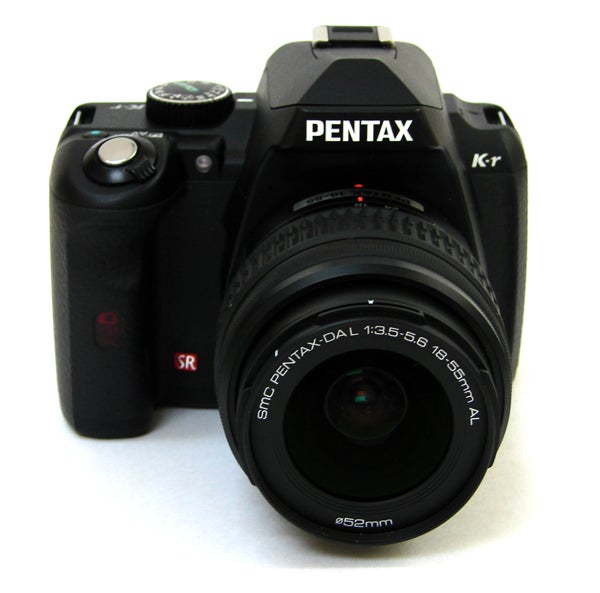 Pentax K-r DSLR camera with lens on white background.