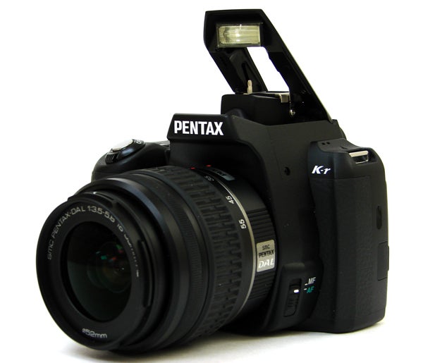 Pentax K-r DSLR camera with pop-up flash raised.