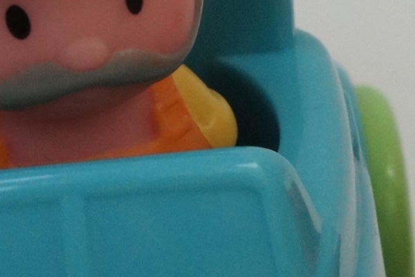 Close-up of a colorful toy figure's face and upper body.