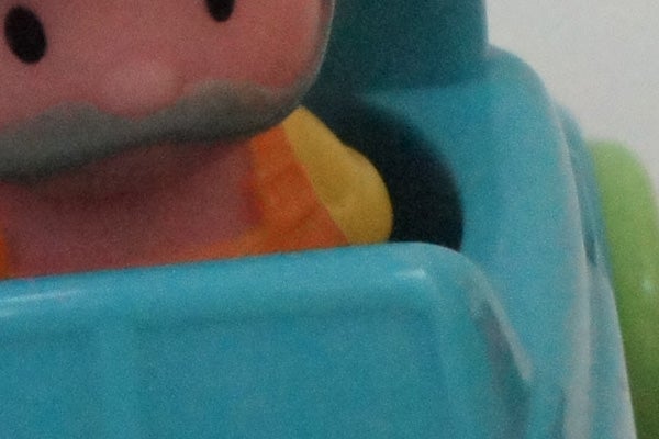 Close-up of a plastic toy's face and upper body.