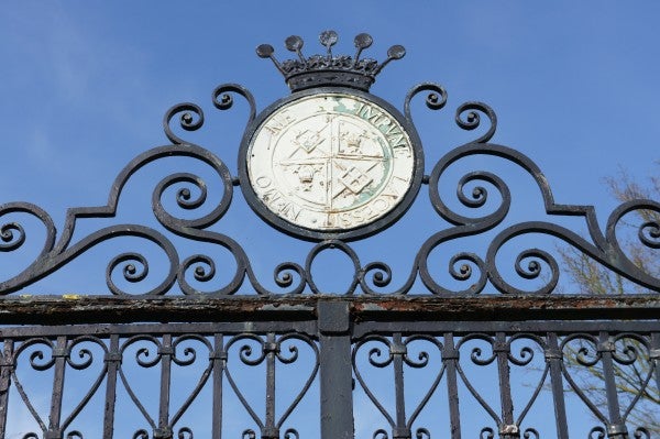 Ornate gate with clock captured by Sony Alpha NEX-3 camera.