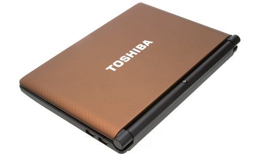 Toshiba NB520 laptop closed with textured brown cover.