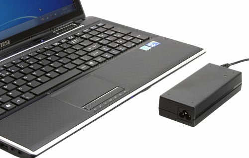 MSI FX600 laptop connected to its power adapter.