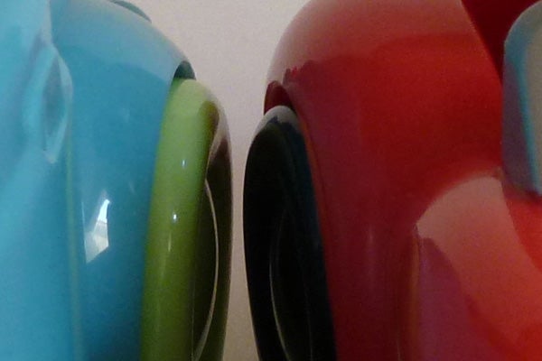 Close-up of colorful ceramic mugs edges.