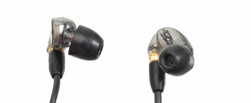 Shure SE425 earphones close-up on white background.